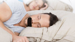 Two people sleeping, one wearing the strip
